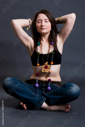 The young woman blindly sits on a floor photo