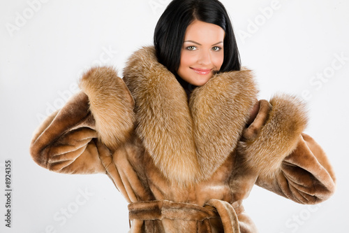 Young attractive woman in furcoat