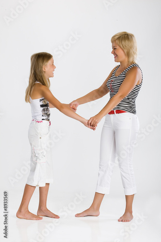 Young blonde woman and girl playing and laughing