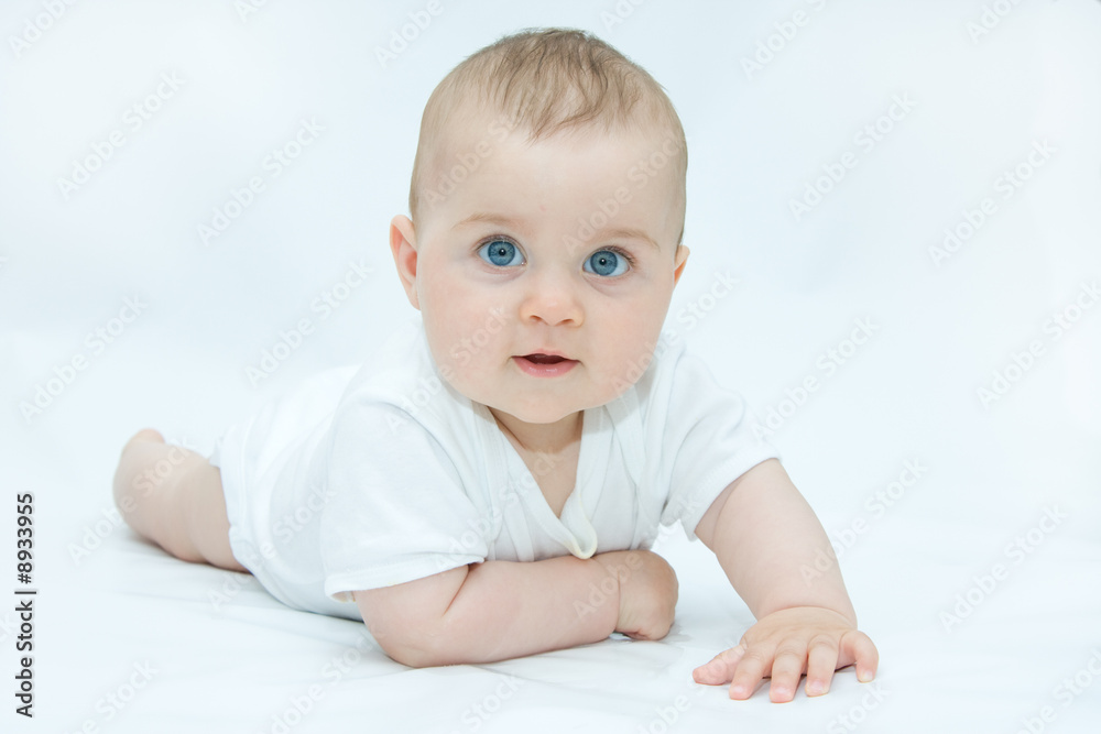 little, cute baby boy lying on white background little, cute baby boy lying on white background