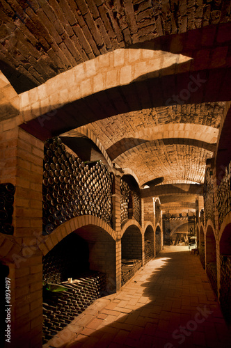 Obraz na plátne Winebottles stacked in the old cellar of the winery.
