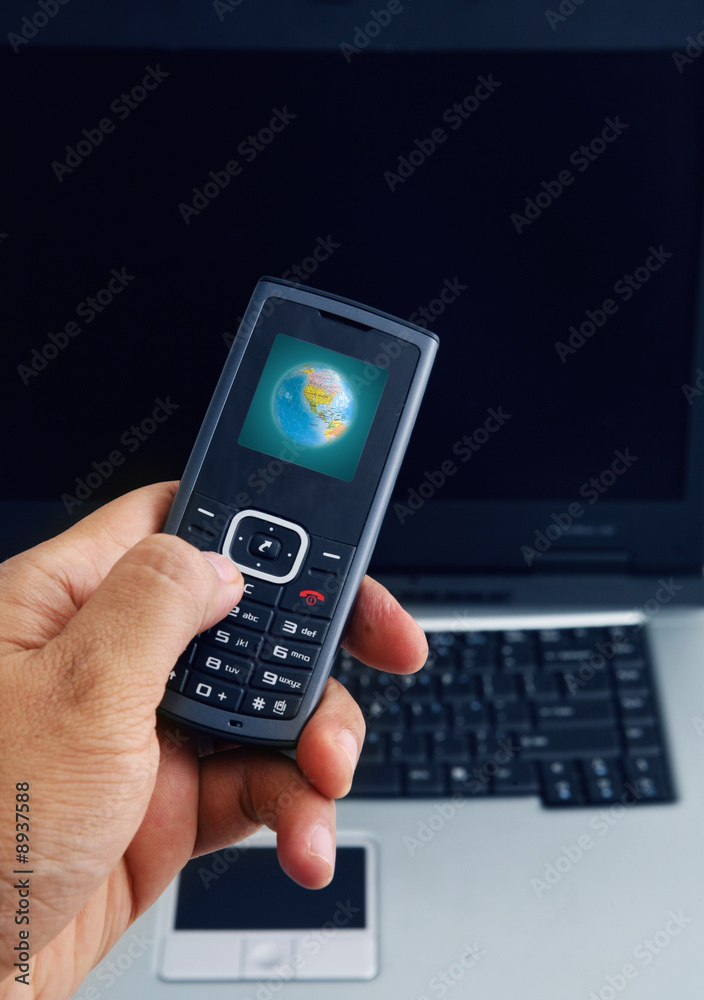Close up shot of mobile phone and a computer laptop Close up shot of mobile phone and a computer laptop