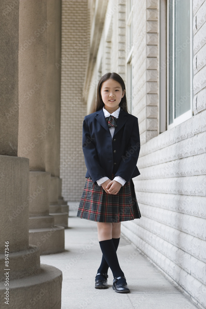 elementary schoolgirl in school uniform foto de Stock | Adobe Stock