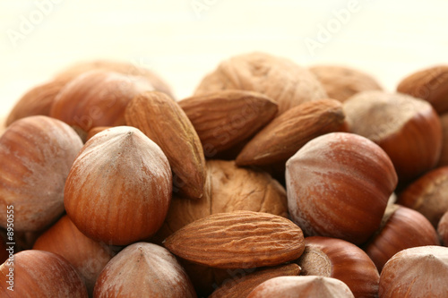 close-ups of hazelnuts and walnuts on wooden table
