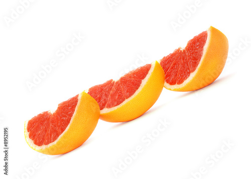 Sliced grapefruits against white background
