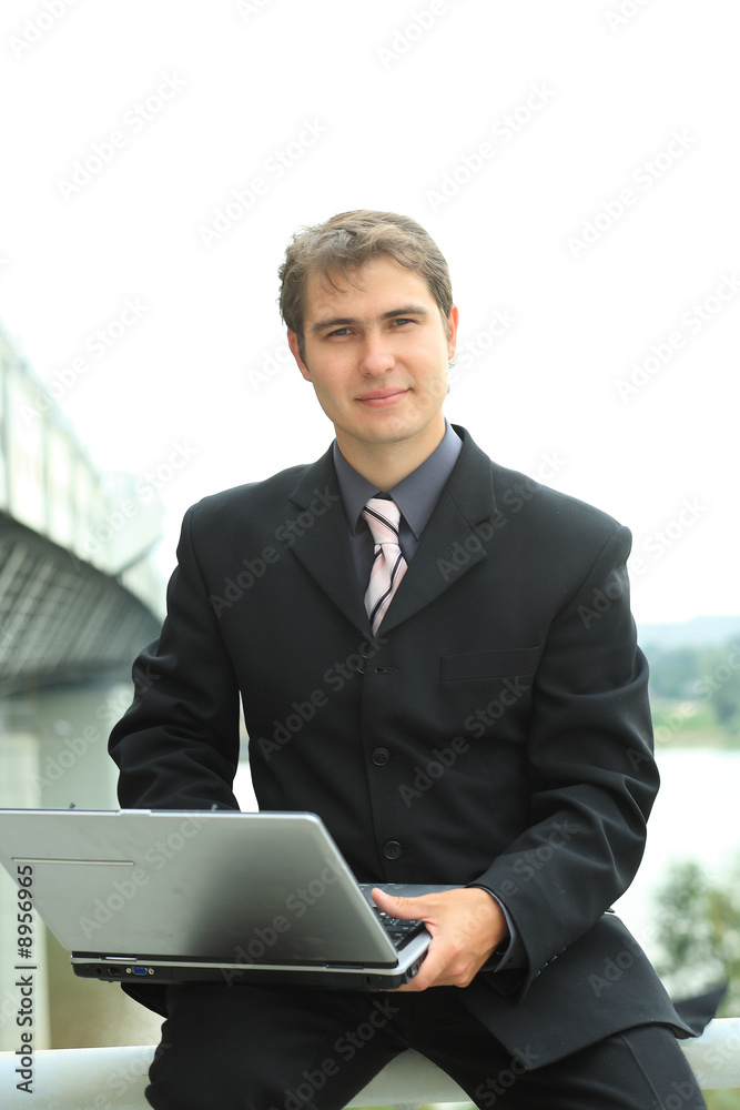 Business background: handsome businessman in a work process.
