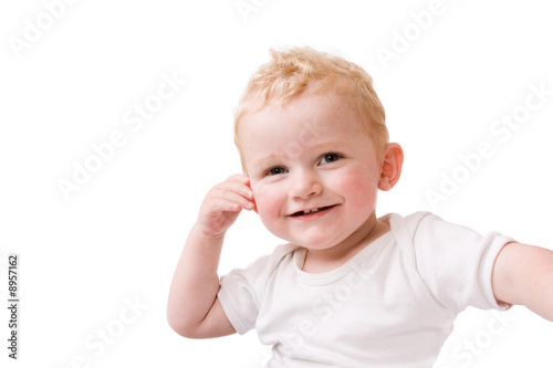 Fotografija Cute caucasian blond toddler is playfull