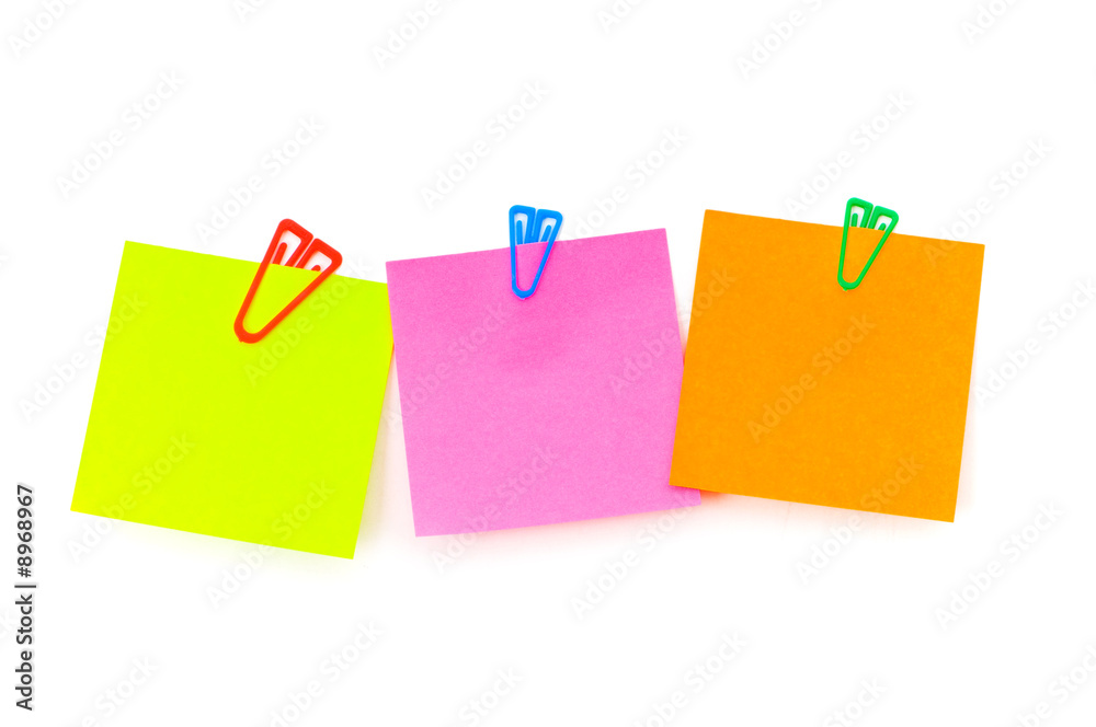 Three notes with paper clips on the white board Three notes with paper clips on the white board
