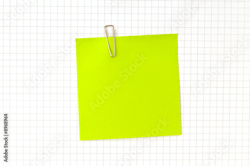 Green note with clip on the paper