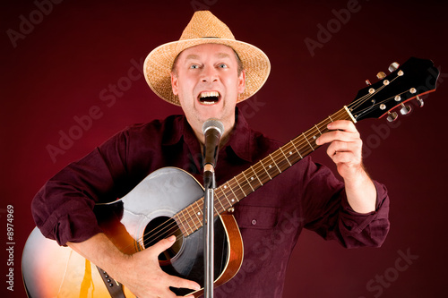 Man is Playing Acoustic Guitar and Singing