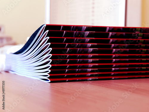 new pink magazines  in pile over desk