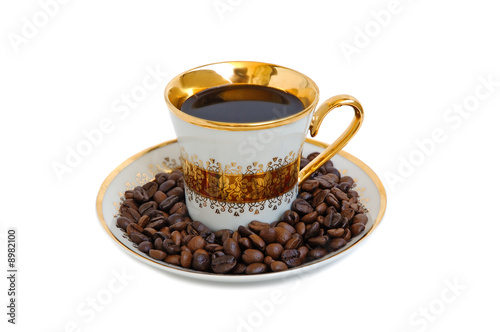 Gold coffee cup with coffee beans