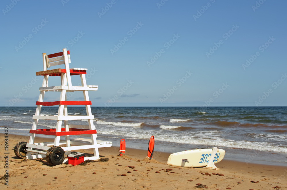 lifeguard chair and beach rescue tools on ocean shore