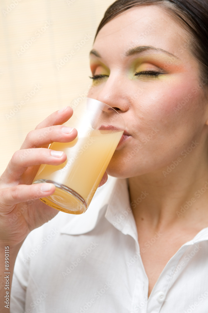 attractive brunette woman drinking orange juice attractive brunette woman drinking orange juice