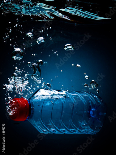 Bottled water on a black/blue background with air bubbles © Dmitriy Melnikov
