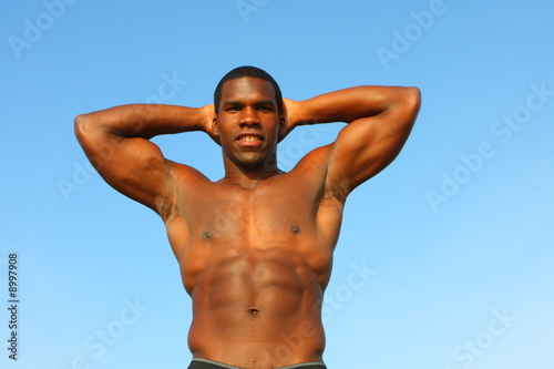 Young man flexing his muscles