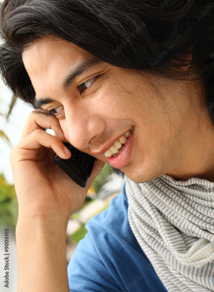 Man smiling and talking on the phone Man smiling and talking on the phone