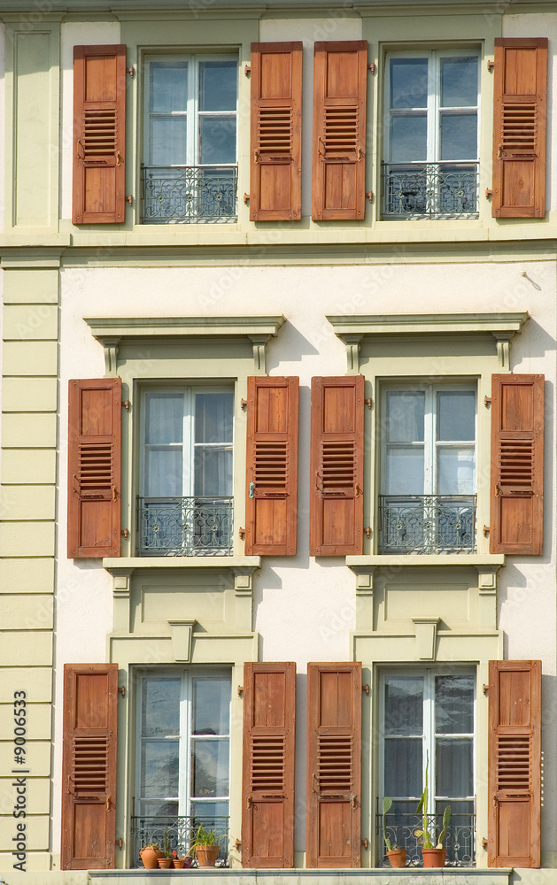 The exterior of an old building with lots of widows