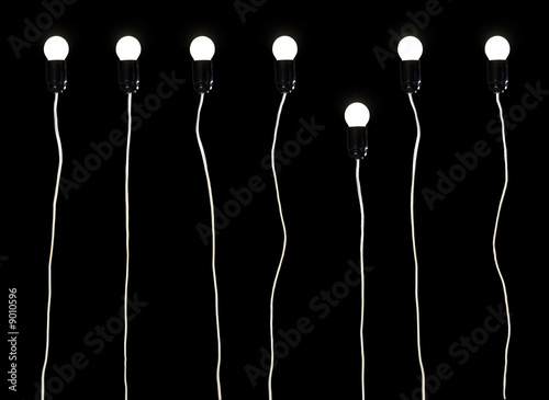 Seven electric lamps on a black background photo