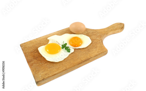 fried eggs on wooden board