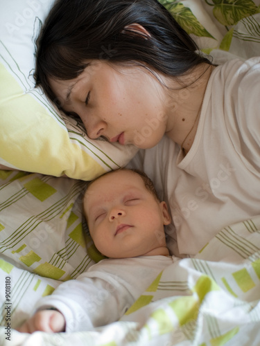 Baby with mom in the bed