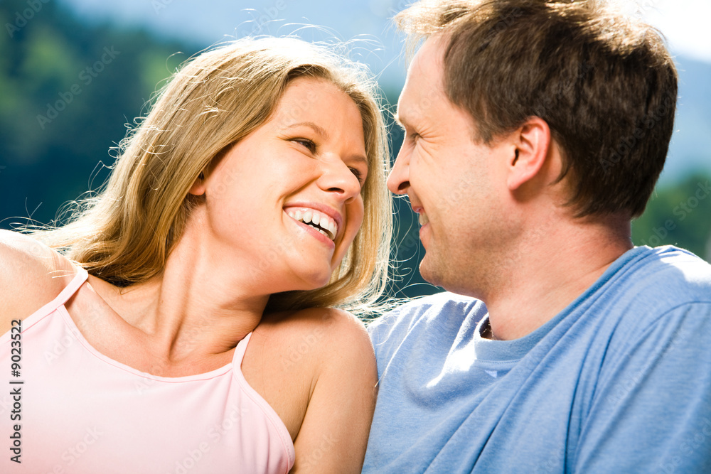 Joyful woman laughing while looking at smiling man Joyful woman laughing while looking at smiling man