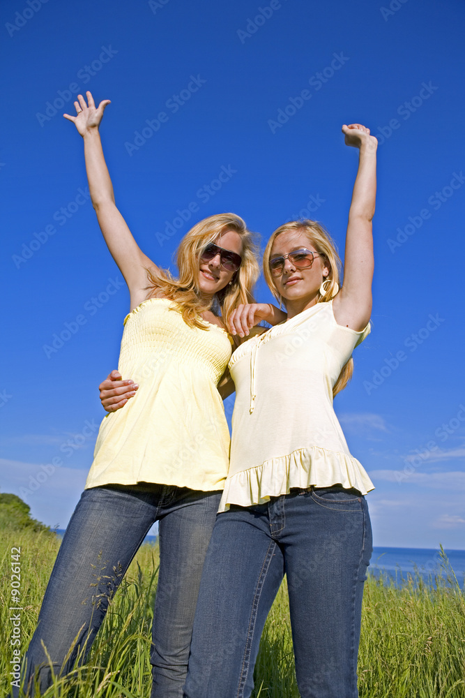 sisters wearing yellow top and jeans in the summer sisters wearing yellow top and jeans in the summer