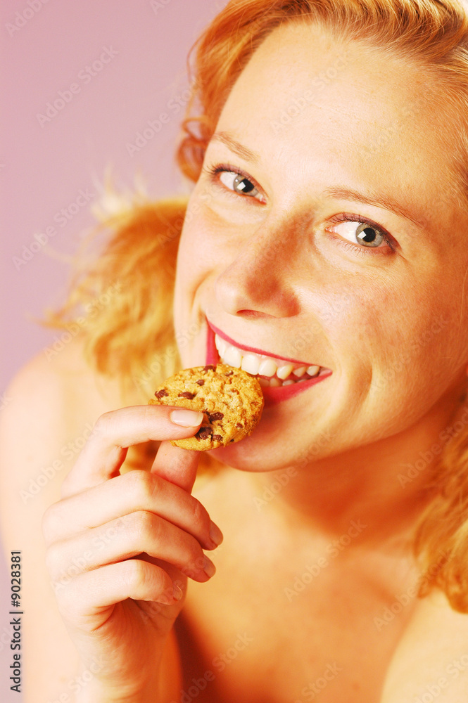 An young blond woman with a biscuit An young blond woman with a biscuit