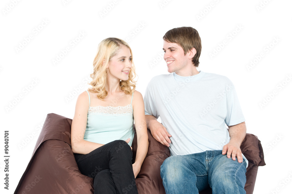 An attractive young couple sitting together