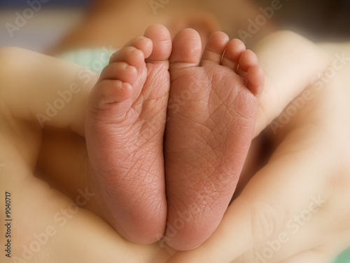 Mother holding her child's feet