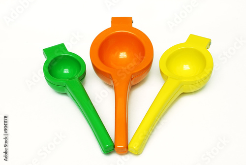 Lime, Orange, and Lemon squeezers on white background