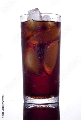 A cola glass with ace in a mirror