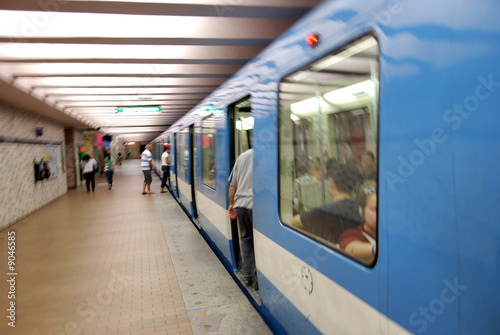 blue subway train in station