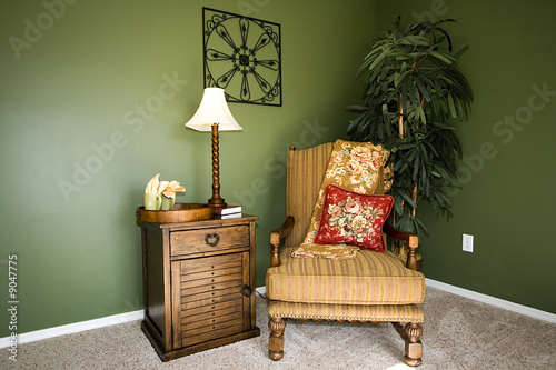 Close up on a corner of a house with a chair and nightstand