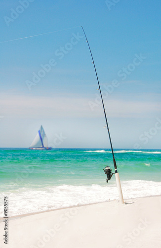 Fishing pole with taut line on ocean beach