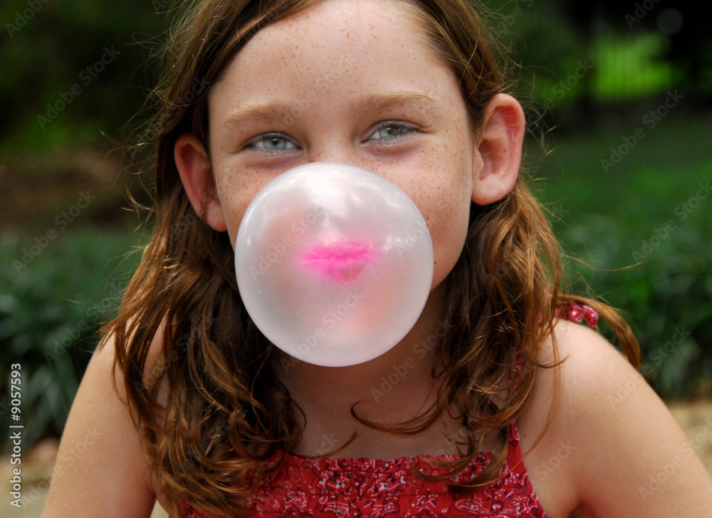 Young girl outside blowing bubble with gum Young girl outside blowing bubble with gum