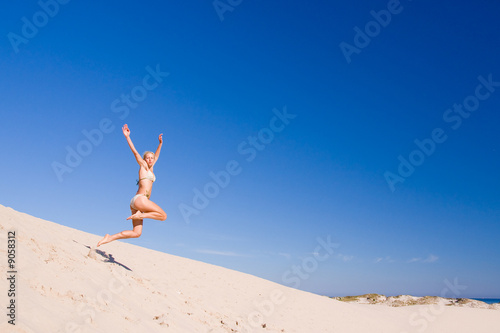beautiful female exercising on the sand dunes © kubais