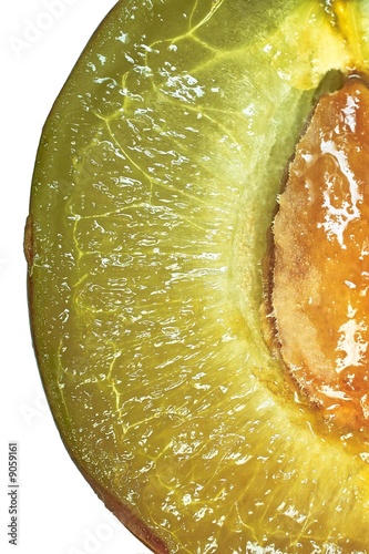 Cut plum juicy pulp and stone, isolated macro image on white