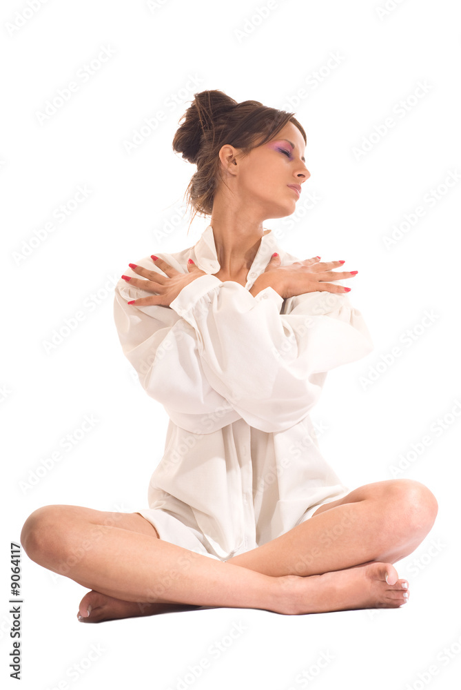 Young woman in white shirt practicing yoga Young woman in white shirt practicing yoga