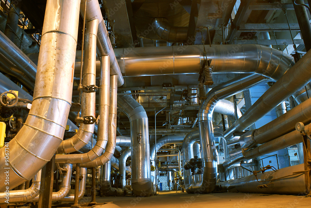 Pipes, tubes, machinery and steam turbine at a power plant Pipes, tubes, machinery and steam turbine at a power plant
