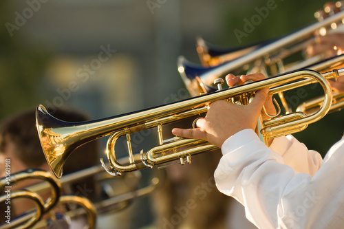 young musicians are playing on trombones