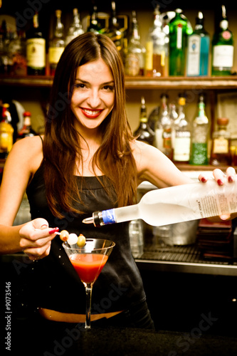A young female bartender, photographed at work.
