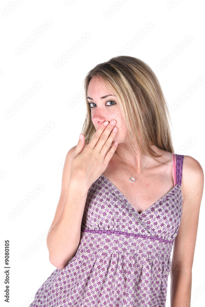 cute teen covering her mouth with her hand cute teen covering her mouth with her hand