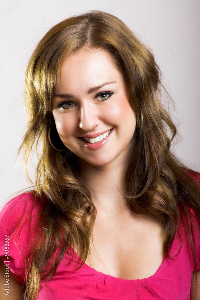 A young, attractive and happy woman is smiling A young, attractive and happy woman is smiling