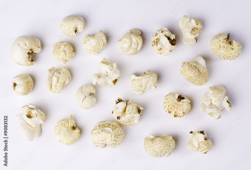 Popcorn grains spilted on white background Popcorn grains spilted on white background