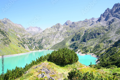 A beautiful alpine lake with resort and vegetation