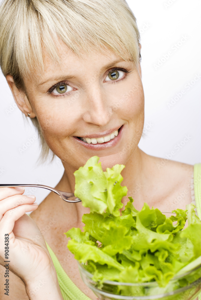 young beautiful blond woman eating salad close up young beautiful blond woman eating salad close up