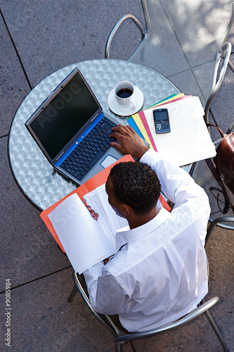 Young Businessman works on a computer outdoors