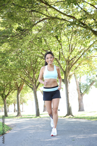 A young pretty asian woman jogging in the park