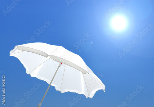 white sunshade on  background of the blue sky © Valua Vitaly